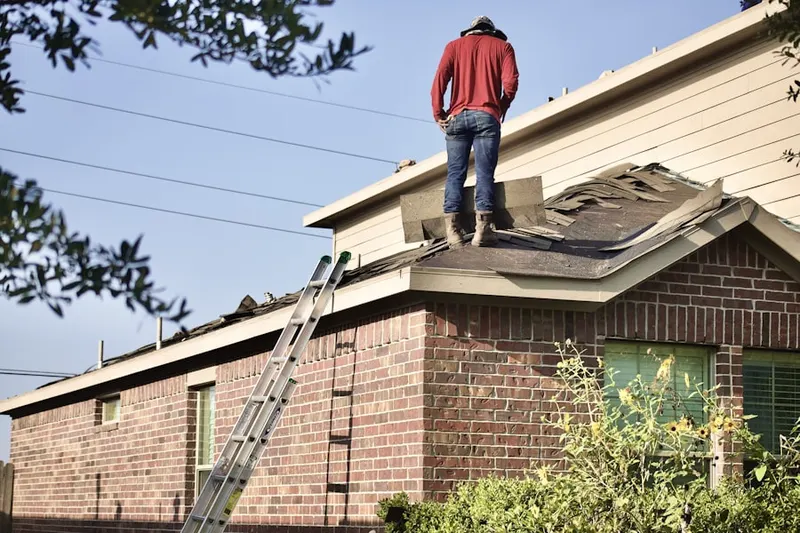Professional roofer working on a residential roof in The Villages at Saybrooke